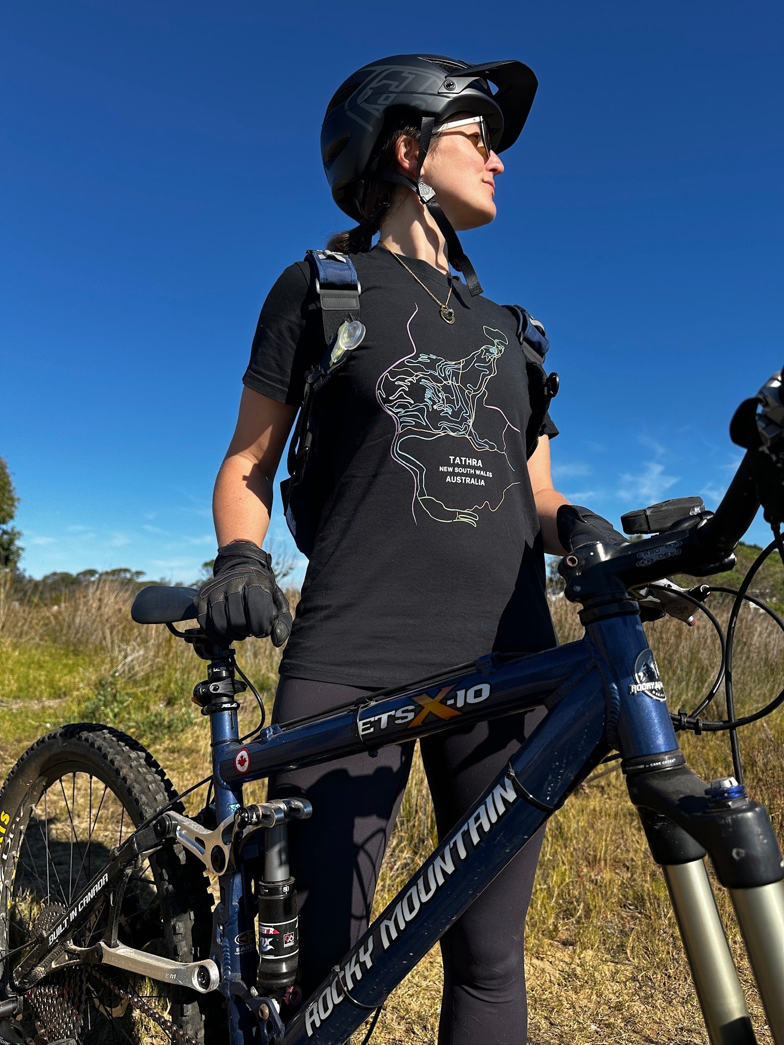 Person with a mountain bike in an outdoor setting