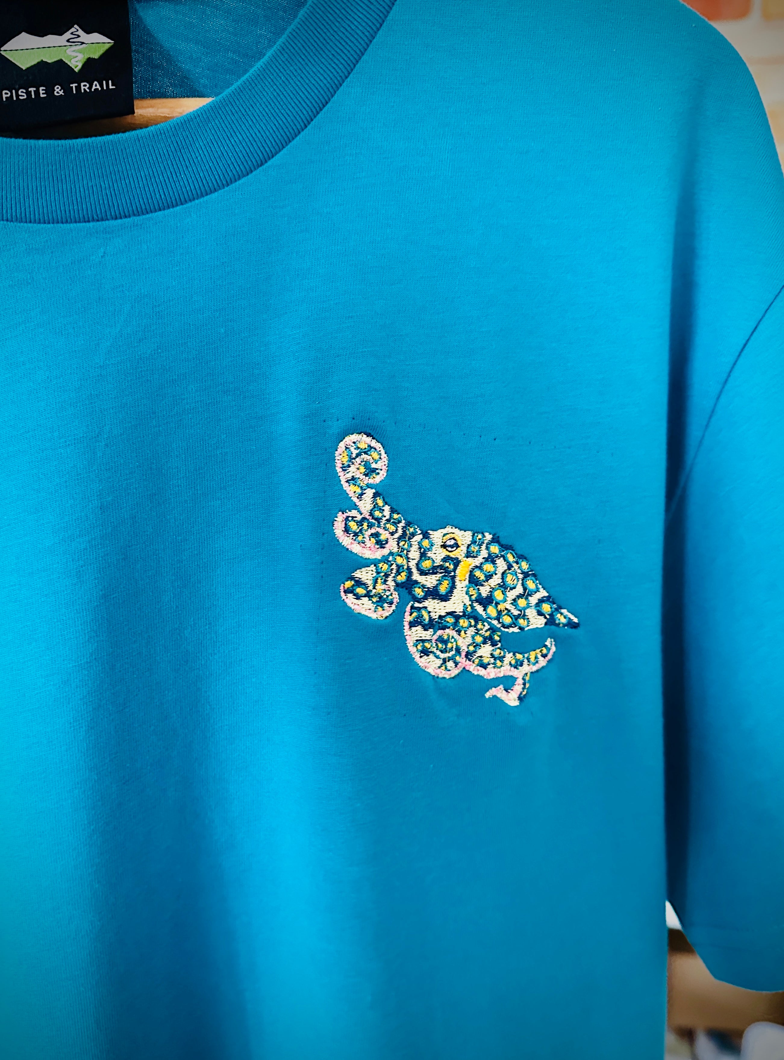 Blue shirt with a blue ringed octopus design on a blurred background